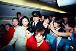 Superstar Jackie Chan puts on a pilot's outfit as he climbs on board a plane arriving from Japan together with Hong Kong Tourism Board (HKTB) Executive Director Clara Chong to greet his fans