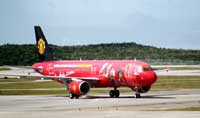 The AirAsia "Red Devils Airbus A320" touches down at KLIA (pictures on acft body : Park Ji Sung, Sir Alex Ferguson and Rio Ferdinand)