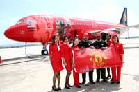 AirAsia's Group Chief Executive Officer, Dato' Tony Fernandes, and Deputy Group Chief Executive Officer, Kamarudin Meranun, posses in front of the newly arrived Airbus A320 which spots a unique livery in conjunction with AirAsia's partnership with Manchester United