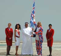 Sir Richard Branson staking his claim to Great Britain on The World in Dubai. Also in the picture is Hamza Mustafa, Miss England and two Virgin staff