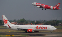 Lion Air Boeing 737-900ER and AirAsia A320 at SoekarnoHatta International Airport in Jakarta, Indonesia.