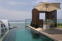 Private infinity edge pool, terrace and garden of a luxurious 2-Bedroom Sky Villa at The Ritz-Carlton, Bali in Indonesia.