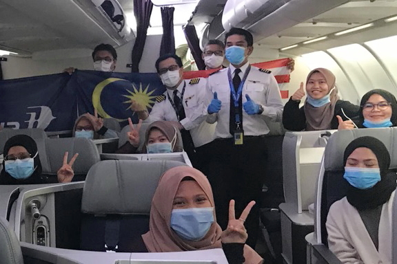 Malaysian students happy to be flying home with Malaysia Airlines from Cairo.. Click to enlarge.