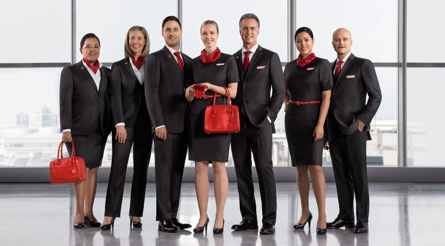 Air Canada's new charcoal grey and black employee uniforms with red accents and accessories by Canadian designer Christopher Bates