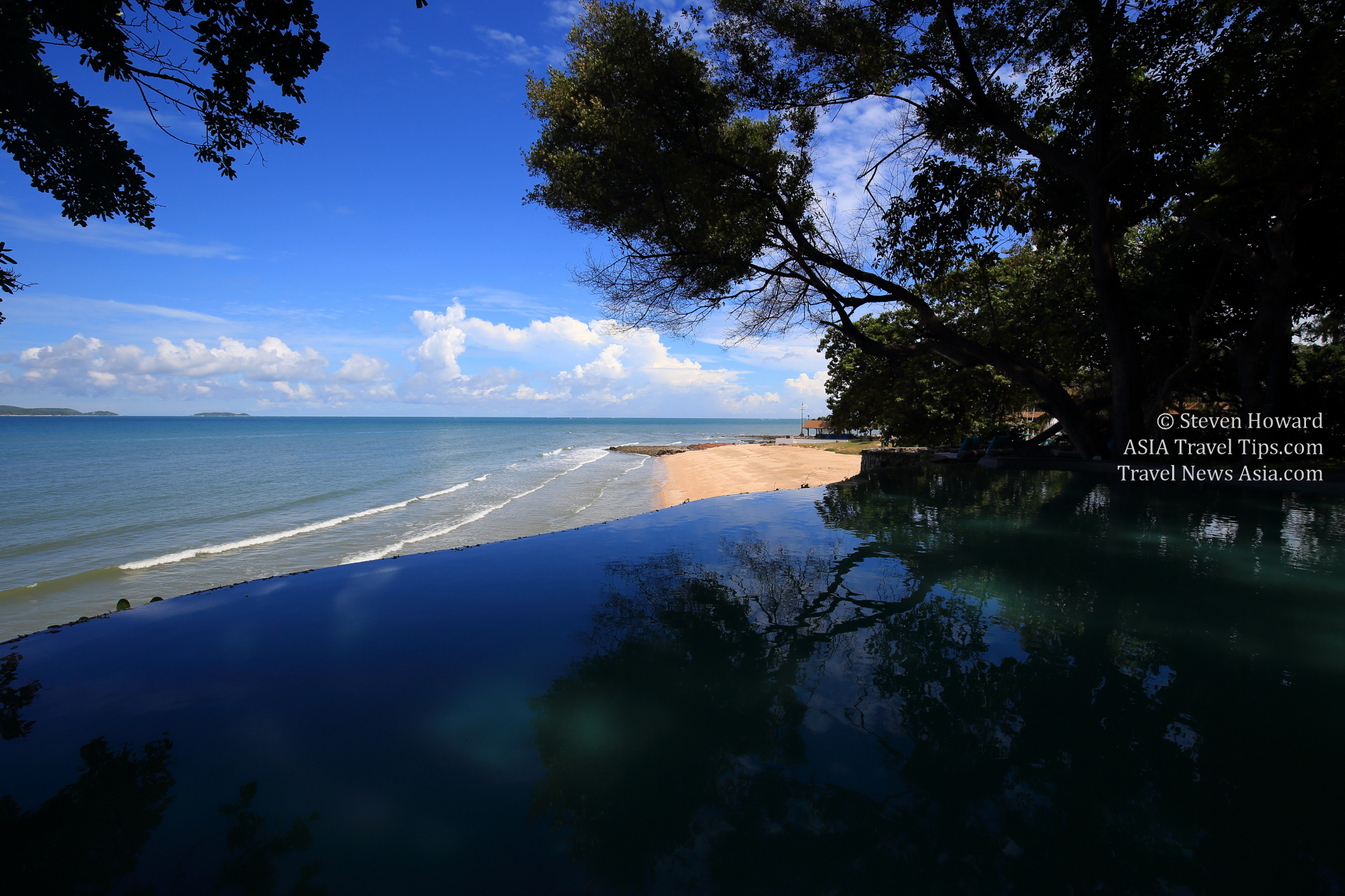 View over the swimming pool and out to sea at the The Monttra Pattaya resort in Thailand