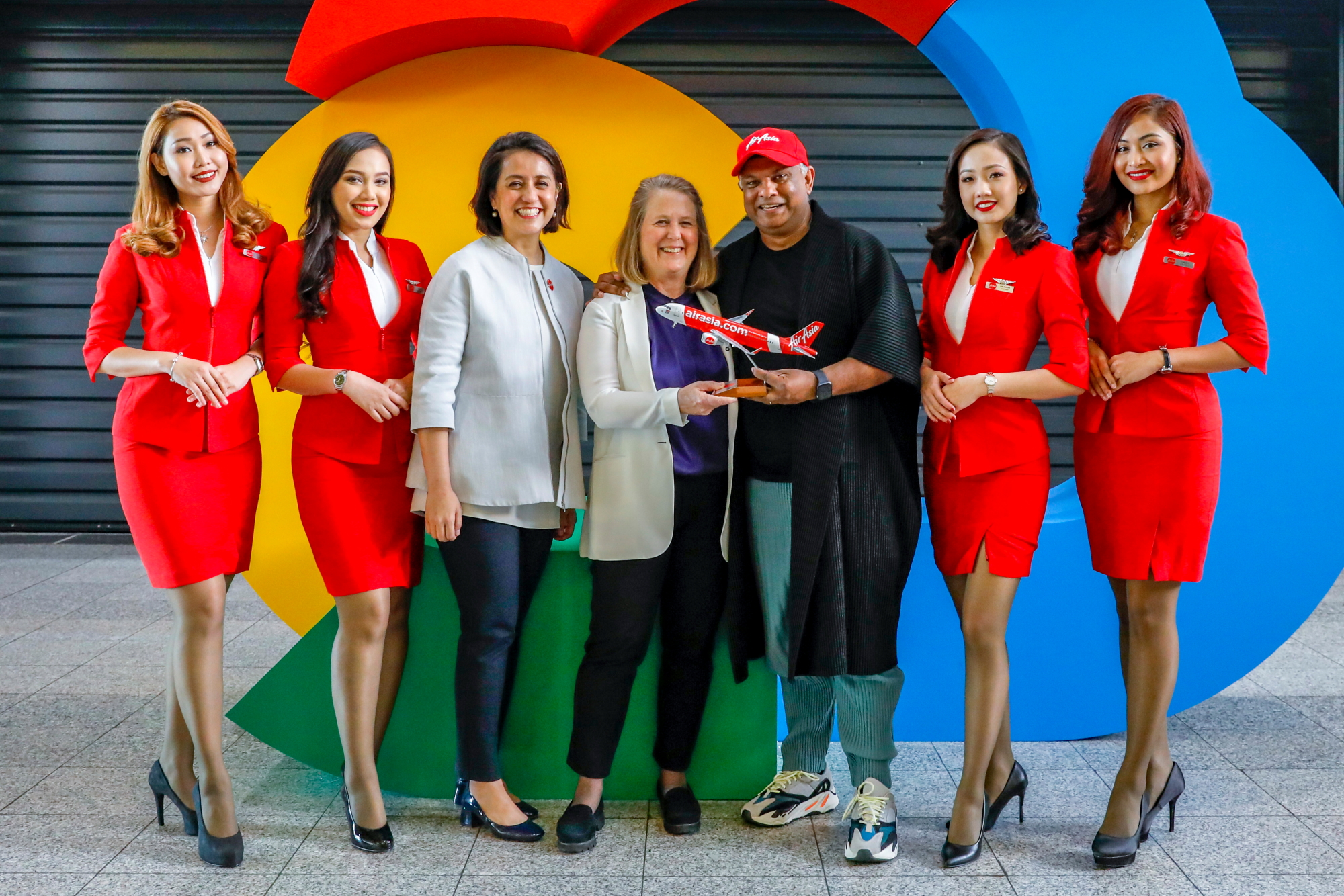 Google Cloud CEO Diane Green (centre), AirAsia Group CEO Tony Fernandes and AirAsia Deputy Group CEO (Digital, Transformation and Corporate Services) Aireen Omar flanked by AirAsia cabin crew at Google Cloud NEXT '18 in London, England. Click to enlarge.