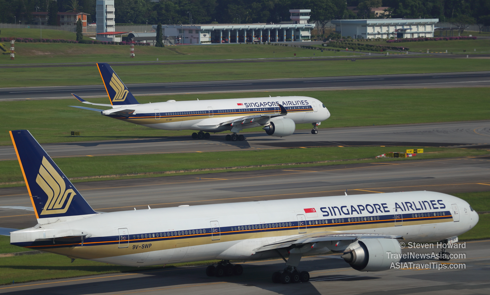 Singapore Airlines Boeing 777 reg: 9V-SWP in the foreground with a Singapore Airlines Airbus A350-900 reg: 9V-SMR in the background. Picture by Steven Howard of TravelNewsAsia.com Click to enlarge.