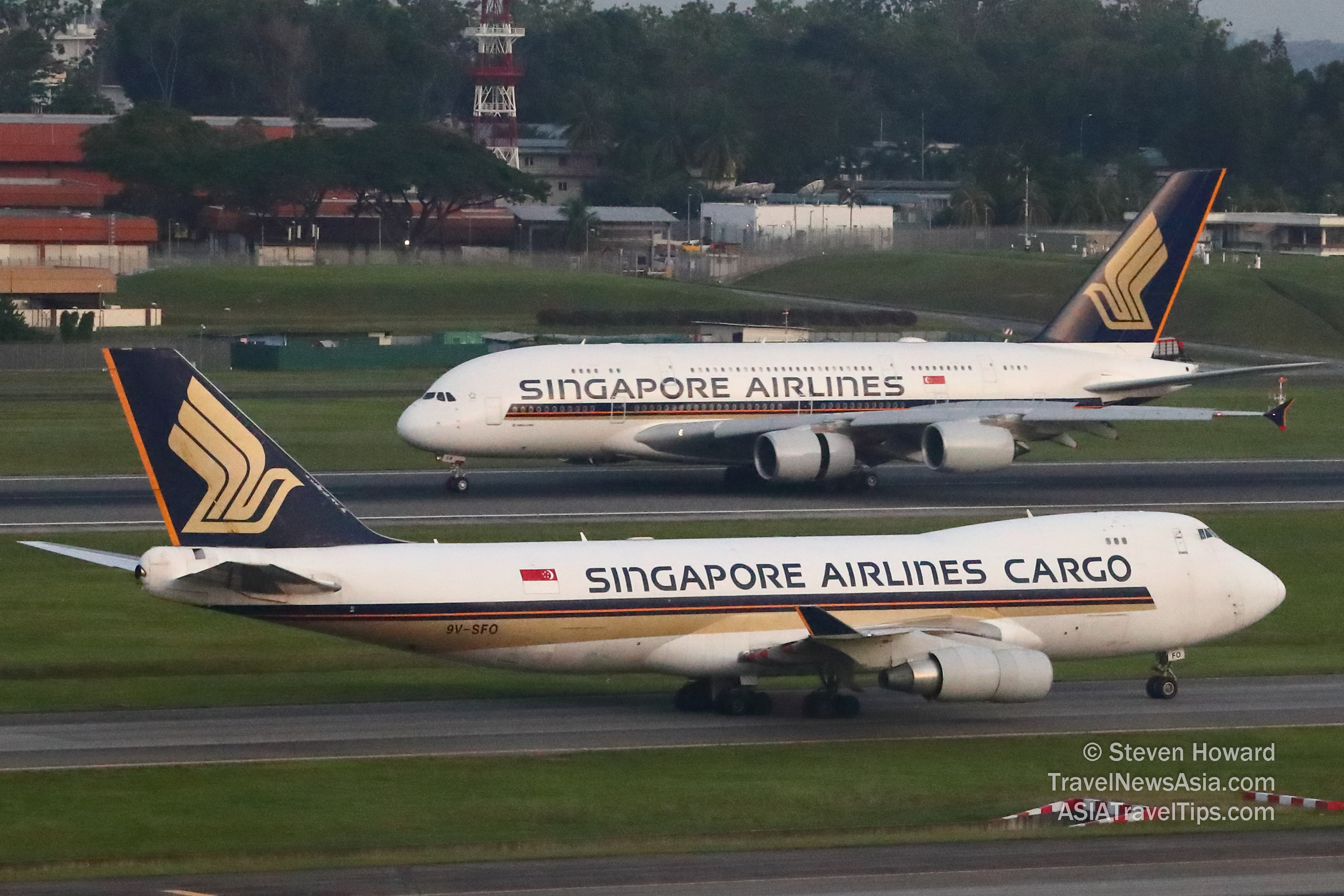 Singapore Airlines Boeing 747-4F reg: 9V-SFO in the foreground with a Singapore Airlines Airbus A380 in the background. Picture by Steven Howard of TravelNewsAsia.com Click to enlarge.