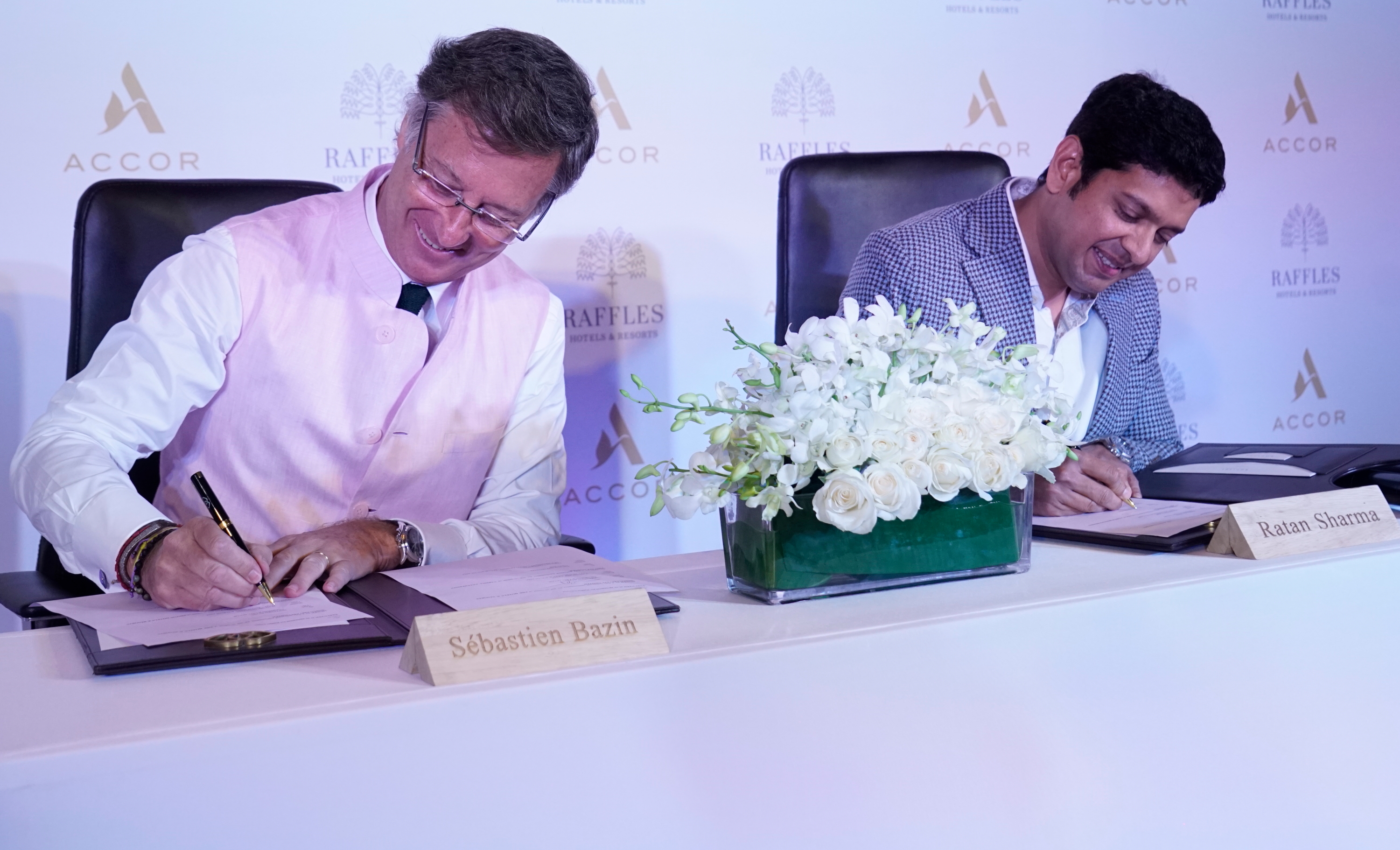 Sébastien Bazin, Chairman and CEO of Accor, signs the deal with owner, Ratankant Sharma Click to enlarge.