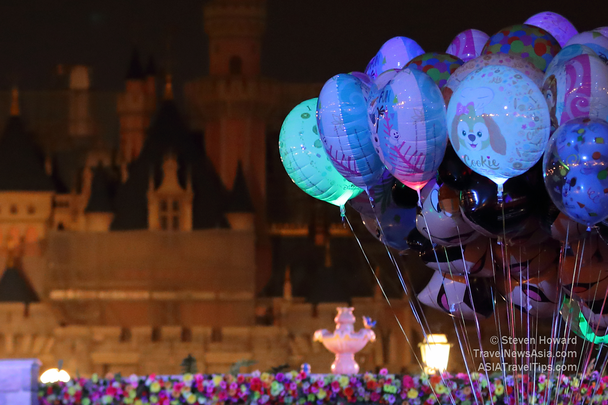 Balloons in the foreground with the blurred image of Hong Kong Disneyland Castle in the background. Picture by Steven Howard of TravelNewsAsia.com Click to enlarge.