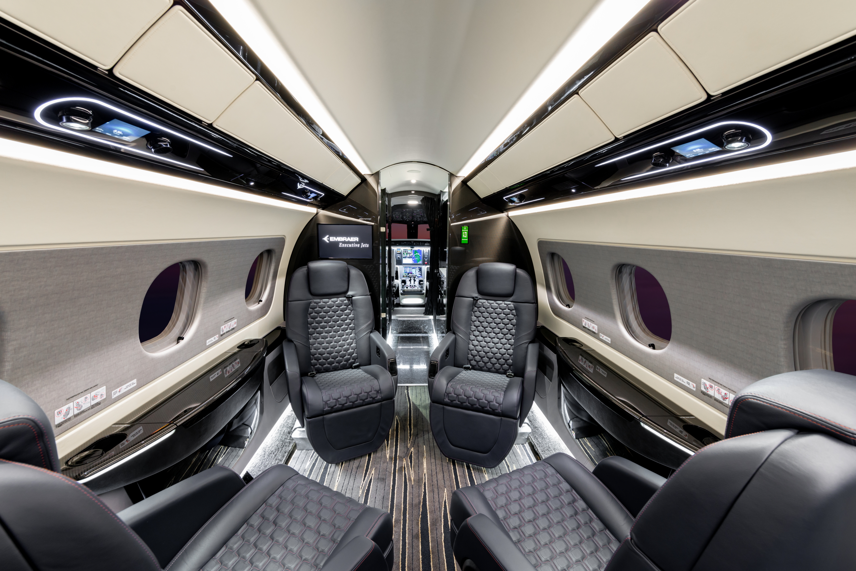 The Embraer DNA Design interior features a six-foot-tall, flat-floor cabin, stone flooring and a vacuum service lavatory. In addition to the full-service galley and a wardrobe, eight fully reclining club seats can be berthed into four beds, and the baggage space is among the largest in its class. Click to enlarge.