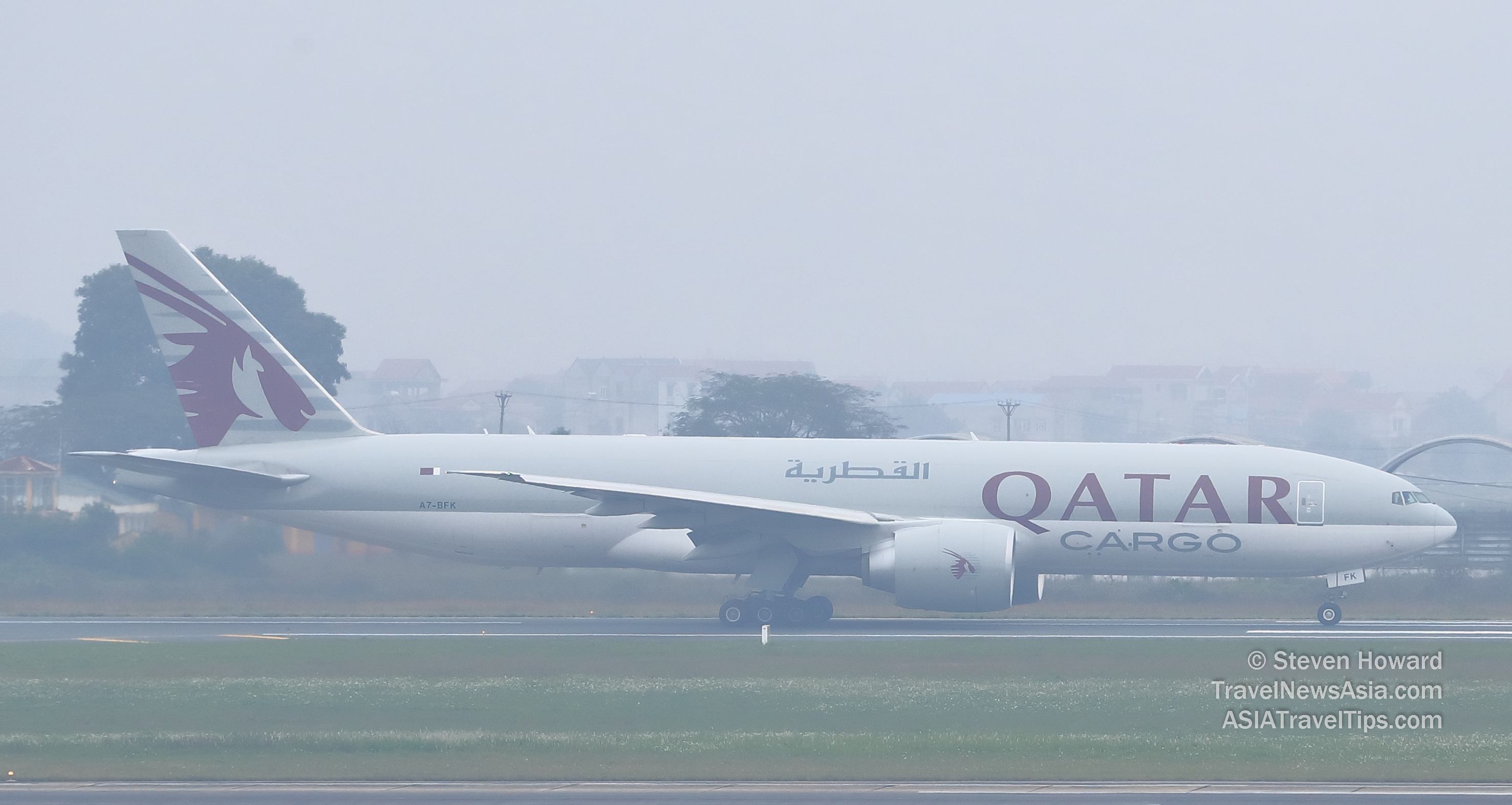 Qatar Airways Cargo Boeing 777F reg: A7-BFK on a very foggy day in Hanoi, Vietnam. Picture by Steven Howard of TravelNewsAsia.com Click to enlarge.